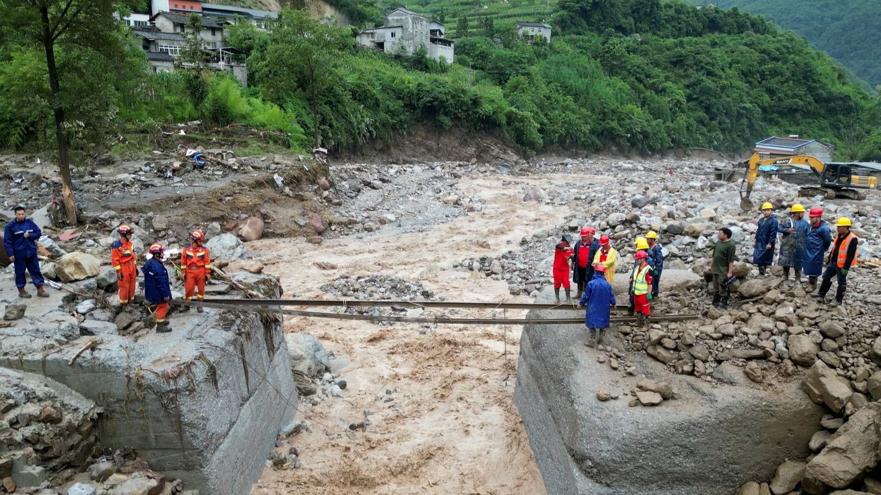 Rescuers Search for Dozens Missing After Flooding and Bridge Collapse in China Kill at Least 25