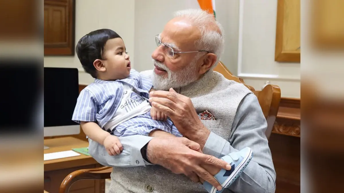 The Viral Baby: PM Modi's Candid Pic With Kid In His Arms Sparks Buzz | Internet Asks 'Who Is He?' The Viral Baby: PM Modi's Candid Pic With Kid In His Arms Sparks Buzz | Internet Asks 'Who Is He?'