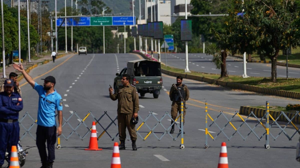 Police officers stand guard at a checkpoint ahead of the second round of negotiations between the U.S. and Iran, in Islamabad, Pakistan, Tuesday, April 21, 2026.