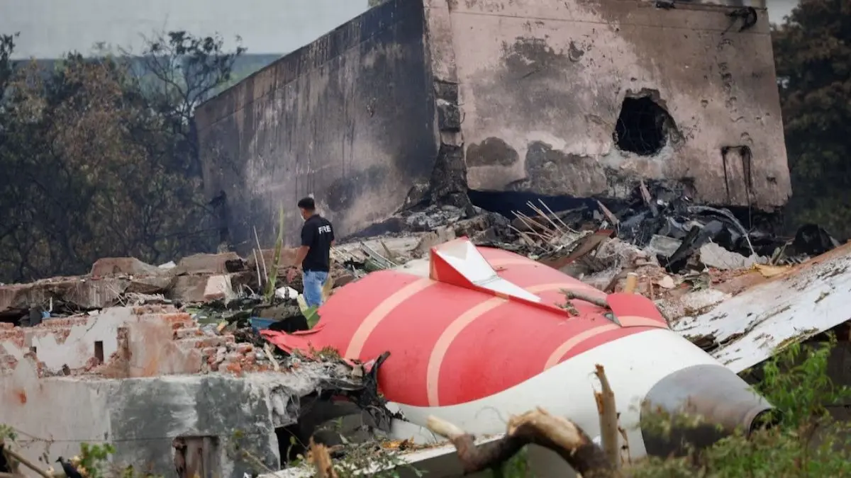 Nation Still In Mourning: Grief Remains Fresh One Year After Deadliest Ahmedabad Air India Crash - 260 Lives Lost, Many Questions Still Unanswered A tail of an Air India Boeing 787 Dreamliner plane that crashed is seen stuck on a building after the incident in Ahmedabad