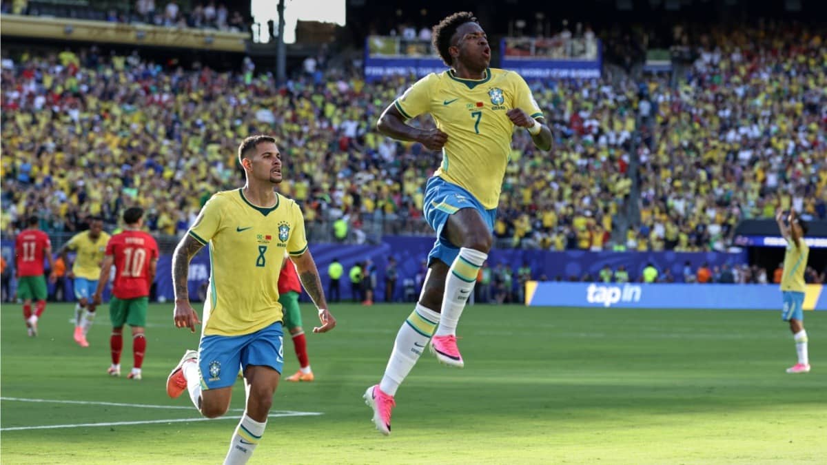 Brazil's Vinicius Junior celebrates with teammate Bruno Guimaraes after scoring against Morocco