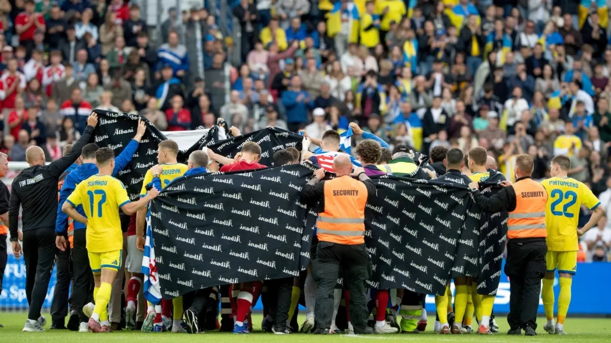 Denmark Great Christian Eriksen 'Conscious' After Collapsing On-Field During Denmark's Friendly Fixture Against Ukraine Denmark's and Ukraine's players accompany Christian Eriksen to a waiting ambulance during friendly match against Ukraine