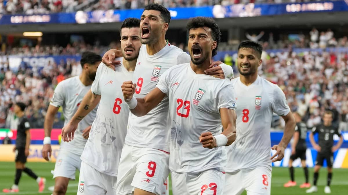 Iran players celebrate their goal