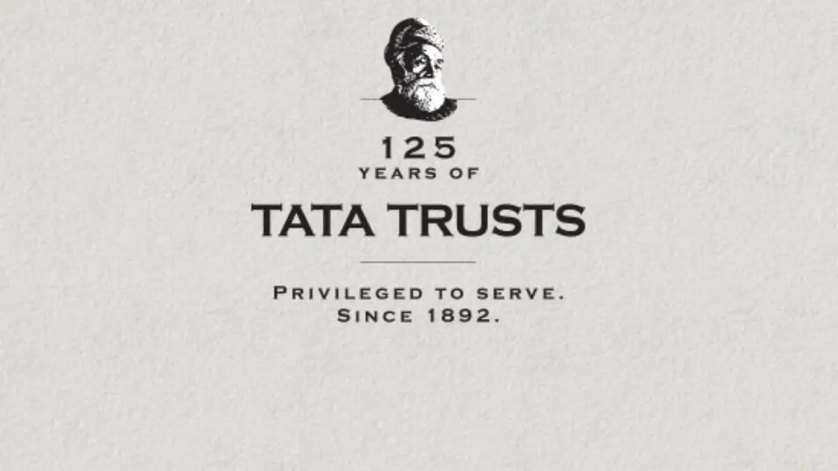 Tata Trusts Refutes Baseless Allegations Over 1989 Share Transfer, Plans Legal Action Tata Trusts logo and headquarters building in Mumbai during a business announcement.