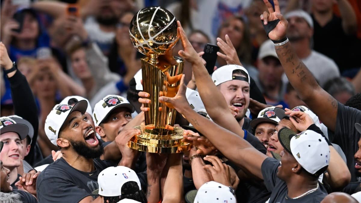 The New York Knicks celebrate with the Larry O'Brien Championship Trophy after defeating the San Antonio Spurs in Game 5 of the NBA Finals basketball series