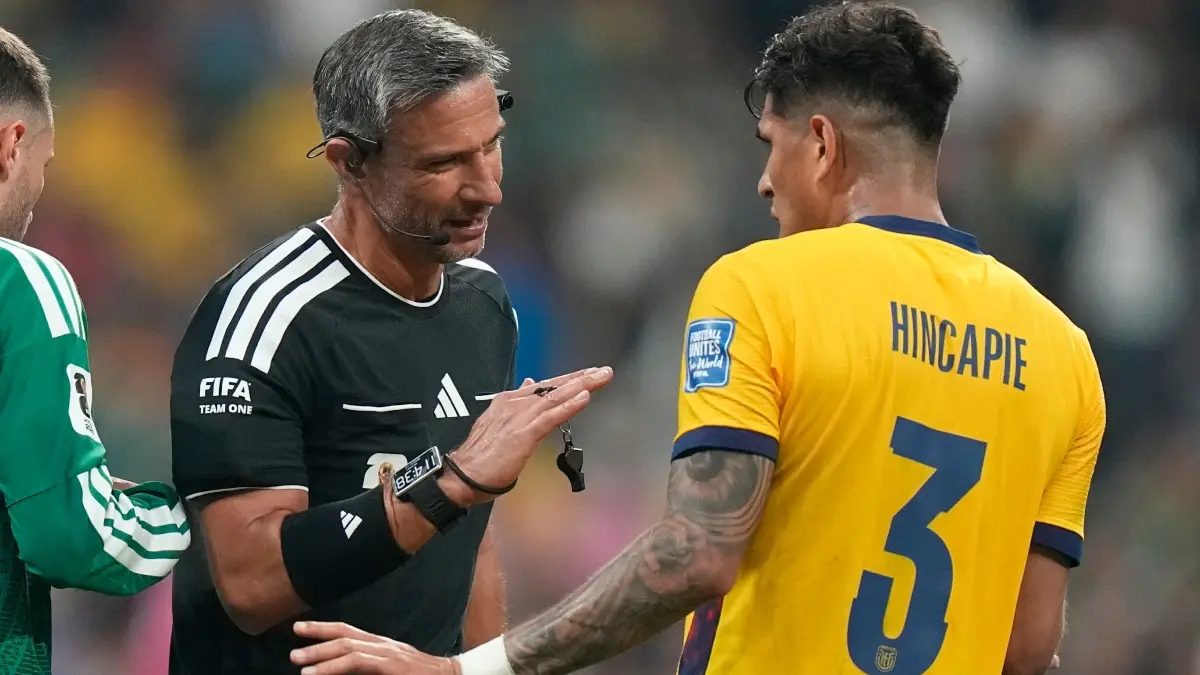 UEFA Set To Defy FIFA Amid Controversy, Will Not Punish Players For Covering Mouths In Champions League Piero Hincapie in conversation with referee