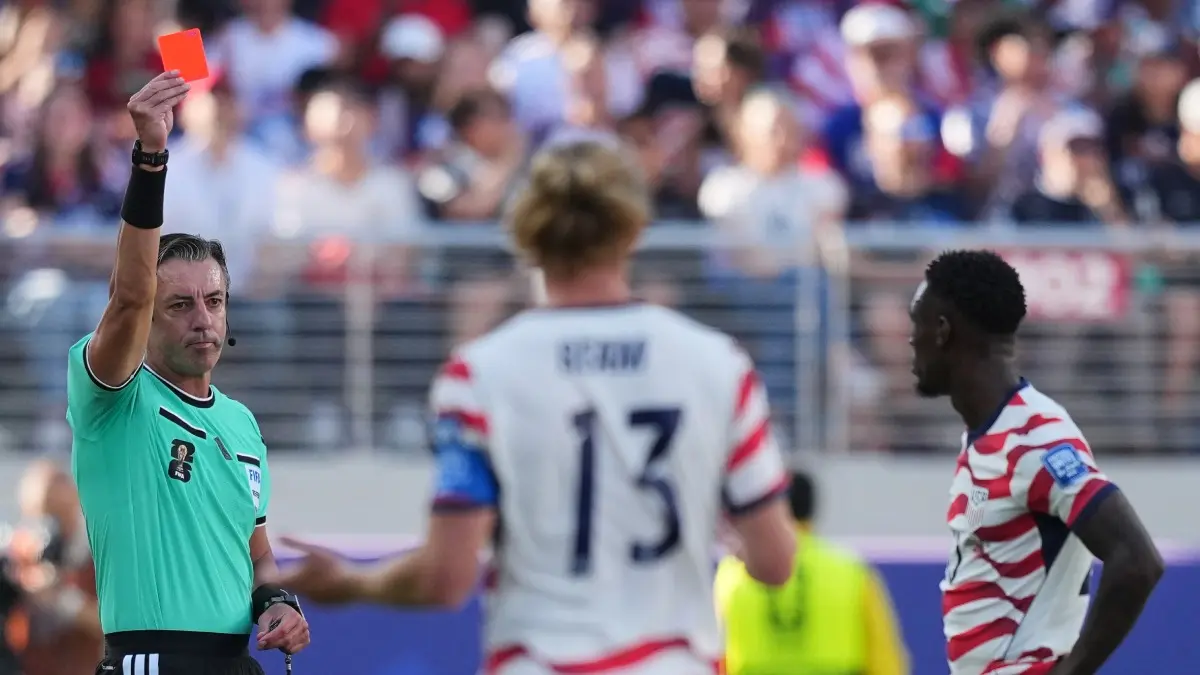 Belgium Given Permission to Appeal 'Controversial' FIFA Ruling On Folarin Balogun Ban Ahead Of RO16 Encounter Referee Raphael Clause shows a red card to Folarin Balogun