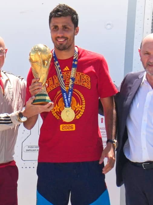Rodri and coach Luis de la Fuente pose with the WC trophy