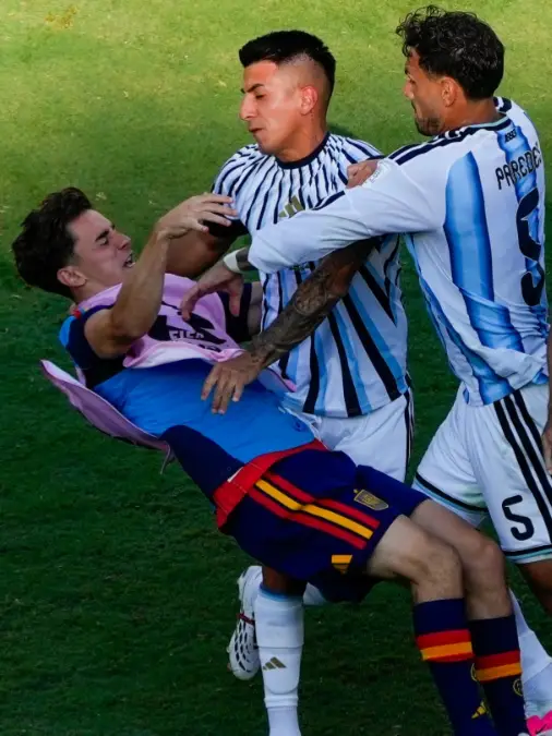 Spain's Gavi falls as he scuffles with Argentina's Leandro Paredes and Thiago Almada after the end of FIFA World Cup 2026 final