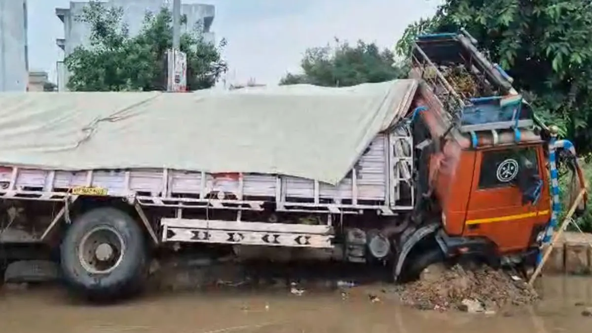 Haryana: Cement-Laden Truck Sinks into Road in Gurugram Sector 9 Amid Heavy Rain, Waterlogging Haryana: Cement-Laden Truck Sinks into Road in Gurugram Sector 9 Amid Heavy Rain, Waterlogging