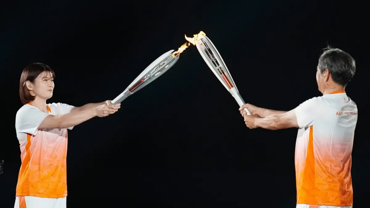 Asian Games 2026: Massive Athlete Count, Unique Sports, Pure Spectacle Japanese athletes Koji Ito, right, and Akari Fujinami with torches