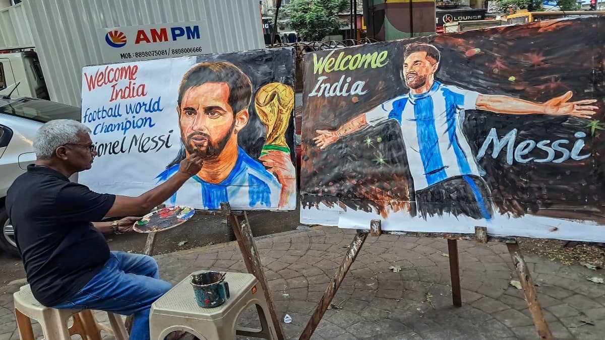 A painter is painting a picture of Lionel Messi