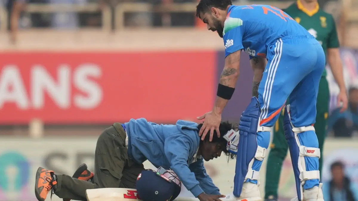 IND vs SA: Pitch Invader Adds To The Grandeur Of Virat Kohli's Iconic Moment In Ranchi As Legendary Batter Smashes 52nd ODI Hundred A pitch invader touches Virat Kohli's feet during the 1st IND vs SA ODI match in Ranchi