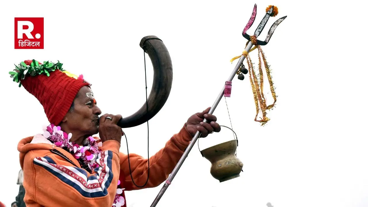 A priest plays a 'Singaa' during the Gangasagar Mela
