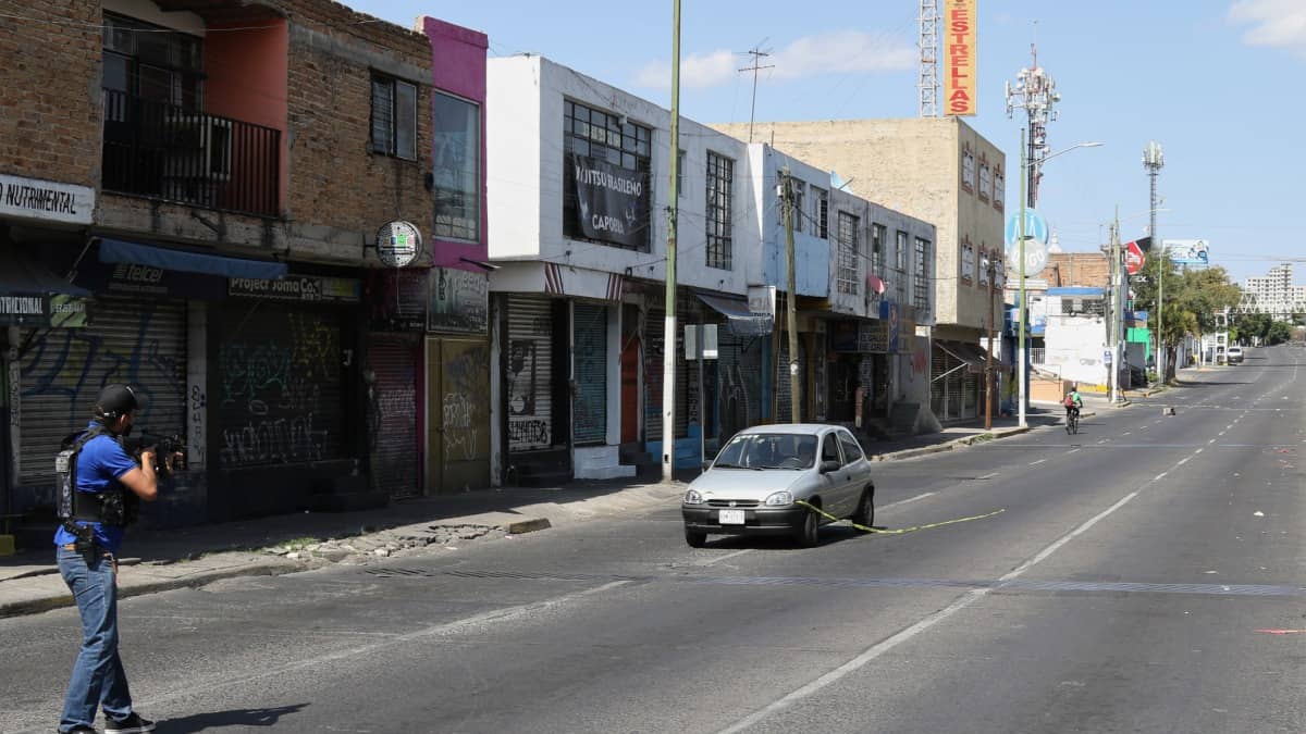 A security official points a gunt at a car