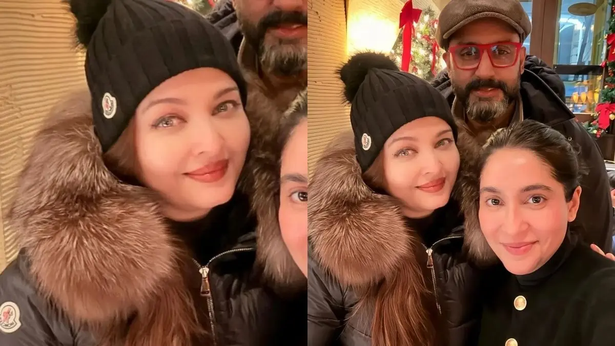 Aishwarya Rai and Abhishek Bachchan poses with a fan.