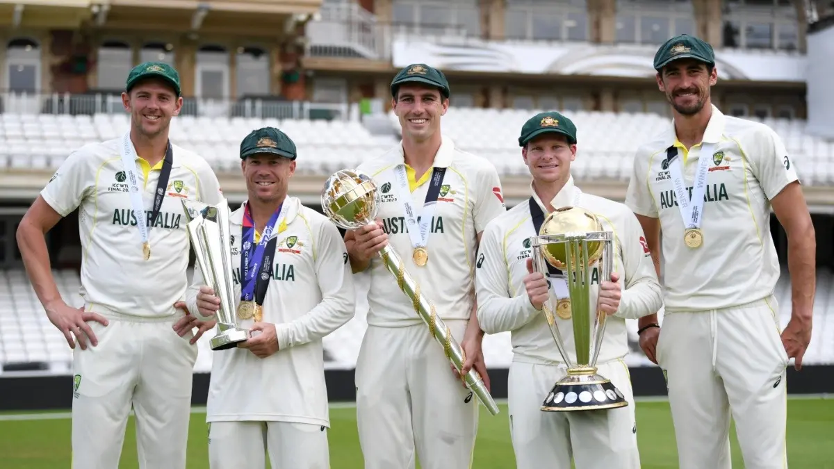 Australia captain Pat Cummins, holding the winning mace, Steve Smith with the winning trophy, along with Mitchell Starc, Josh Hazlewood, and David Warner, celebrate after winning the ICC World Test Championship Final 2023 against India
