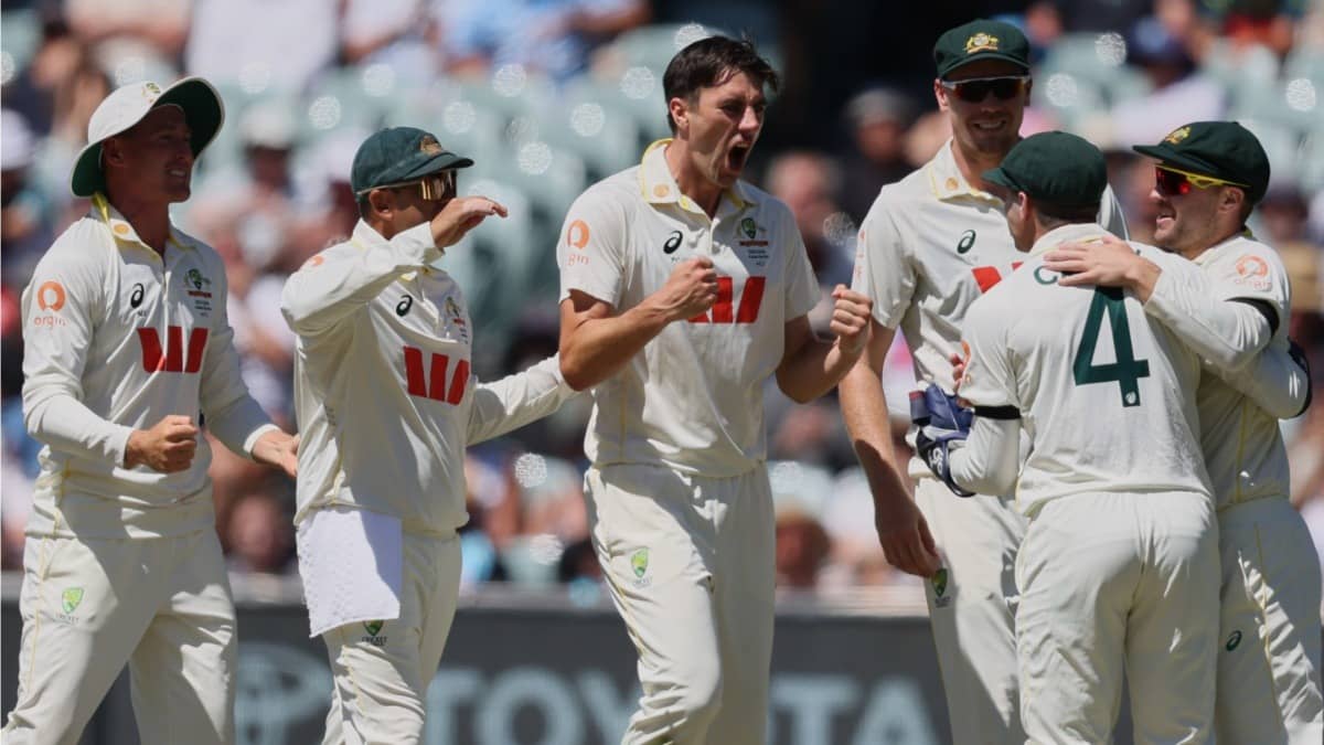 Australia's Pat Cummins, centre, celebrates with teammates after taking the wicket of England's Joe Root in the Adelaide Test