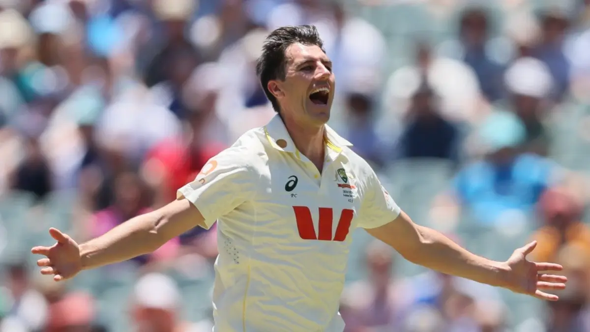 Australia's Pat Cummins, centre, celebrates with teammates after taking the wicket of England's Joe Root in the Adelaide Test