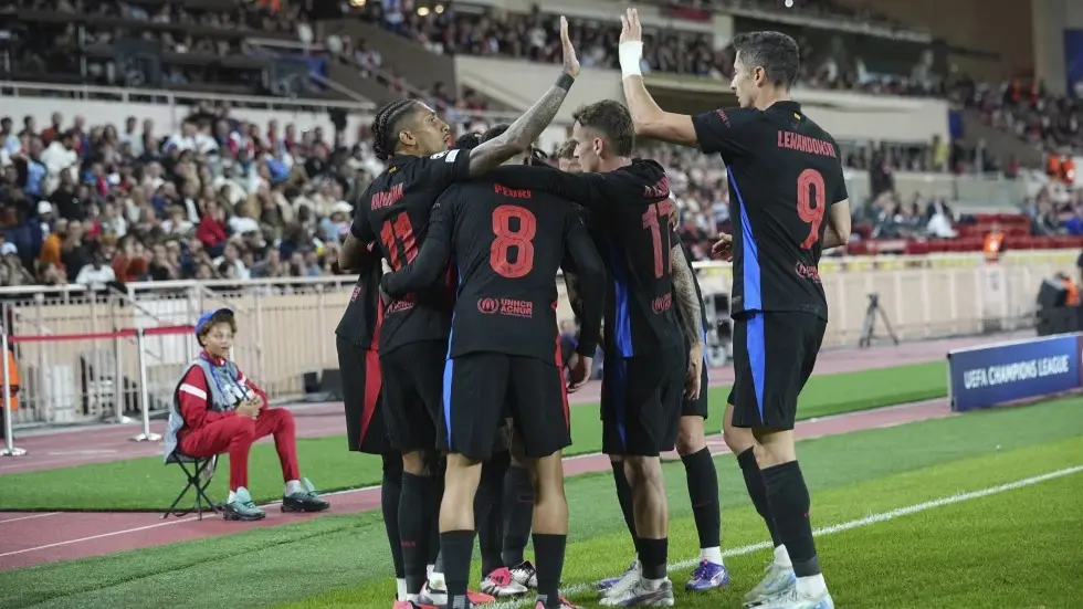 Barcelona players celebrate against Monaco.