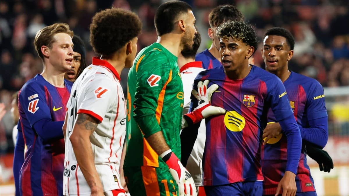 Barcelona's Lamine Yamal argues with Girona's Joel Roca and Axel Witsel during La Liga matchy