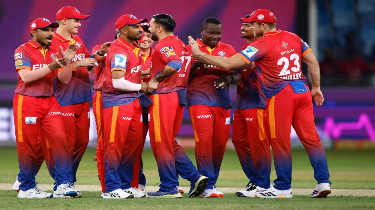 Dubai Capitals players celebrate a wicket