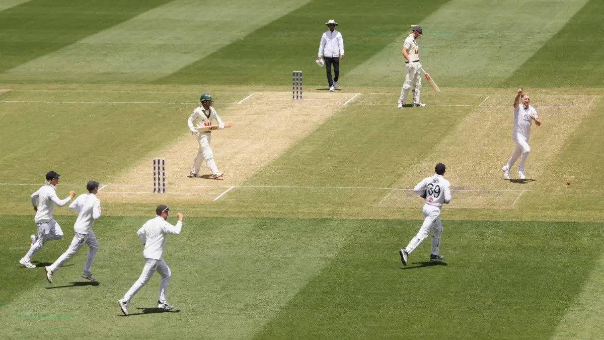 England's Ben Stokes, right, celebrates the wicket of Australia's Alex Carey, fourth left, during Melbourne Test