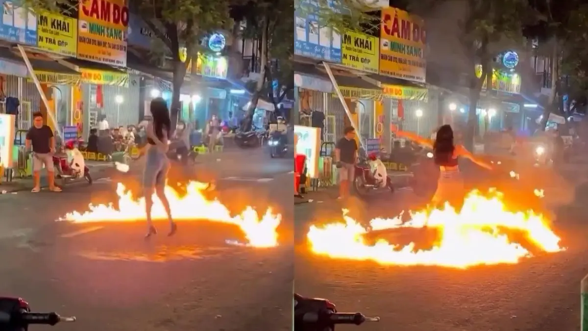 Girl dances in a fireball in the middle of the road