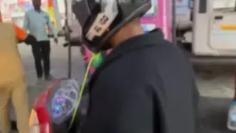 Helmet attached with string offered to biker at petrol pump station in Bokaro