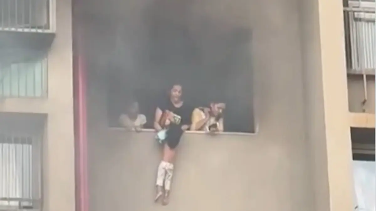 In a dramatic fire rescue in Ahmedabad, a child was seen dangling from a window.