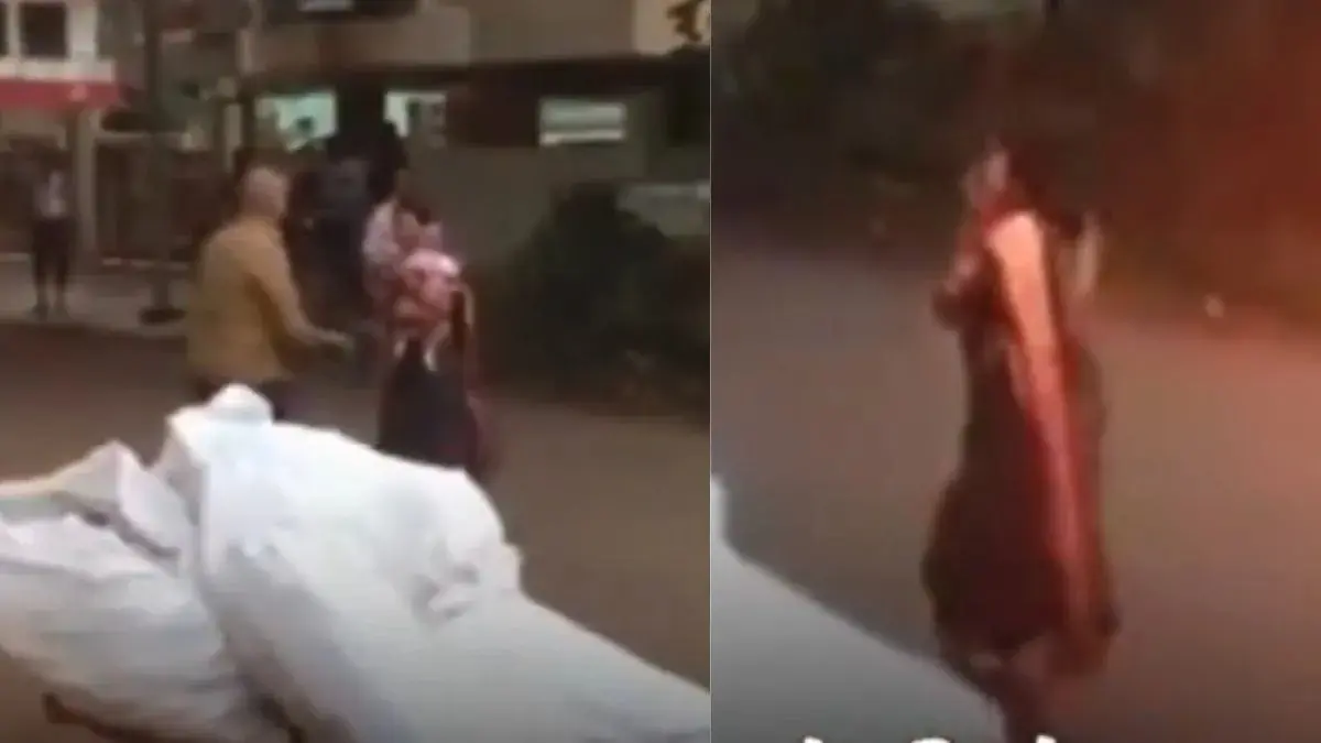 In the clip, a mother is seen walking away from a park while talking on her phone, seemingly forgetting her child behind.