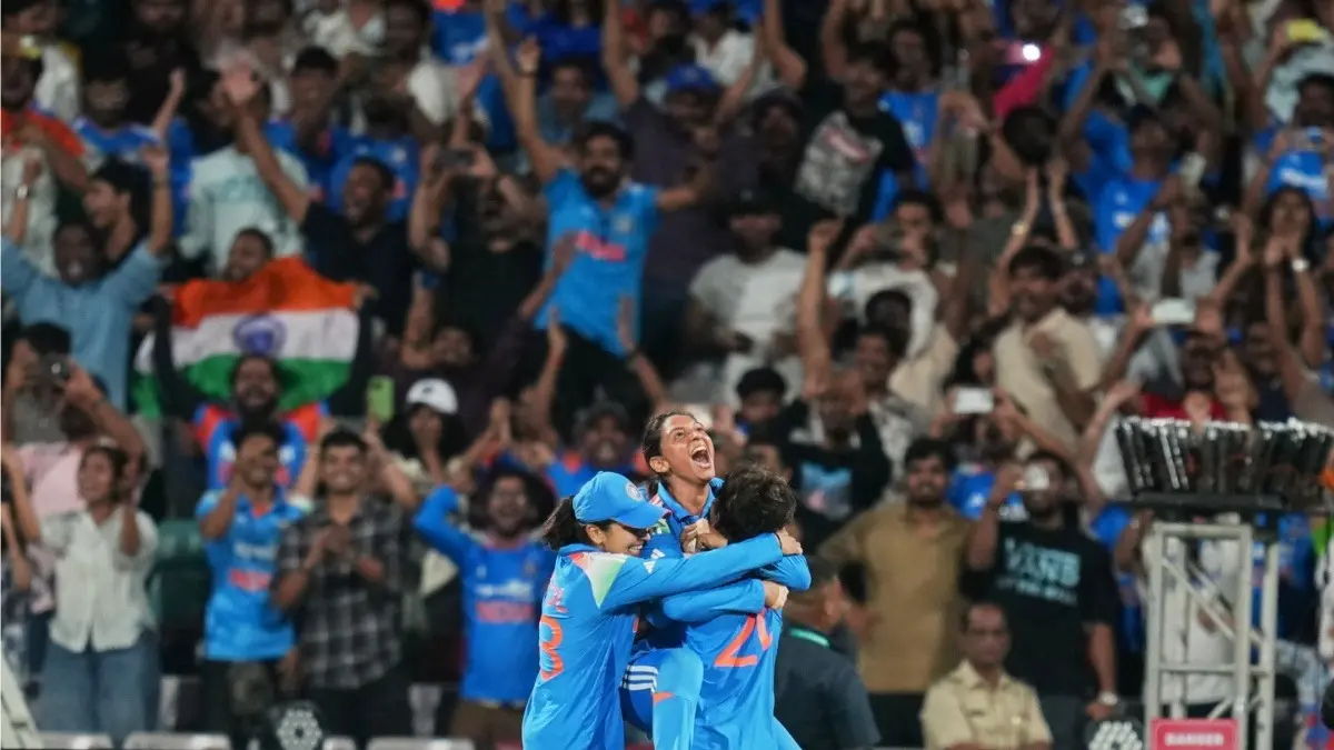 India's captain Harmanpreet Kaur celebrates with teammates after winning the ICC Women's Cricket World Cup final against South Africa