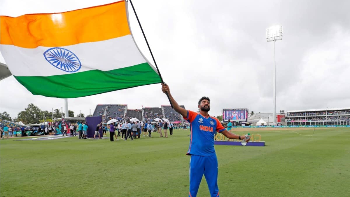 India's Mohammed Siraj waves the National flag after Team India T20 World Cup 2024 win