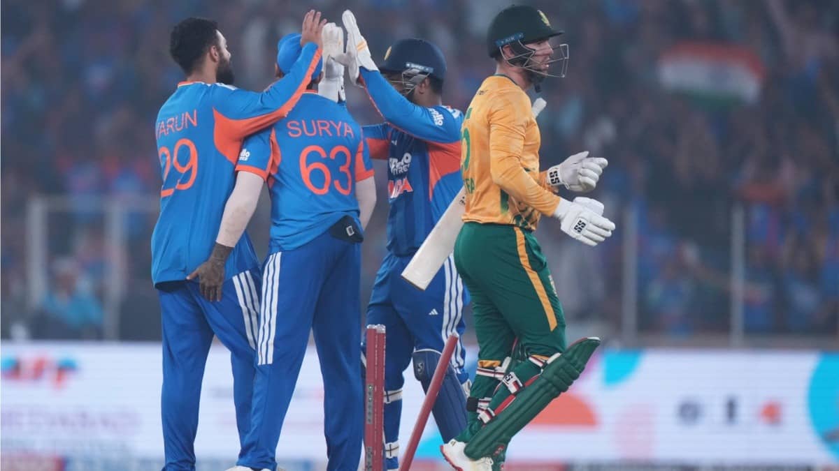 India's Varun Chakaravarthy, left, celebrates with teammates the wicket of South Africa's Donovan Ferreira in the fifth T20I