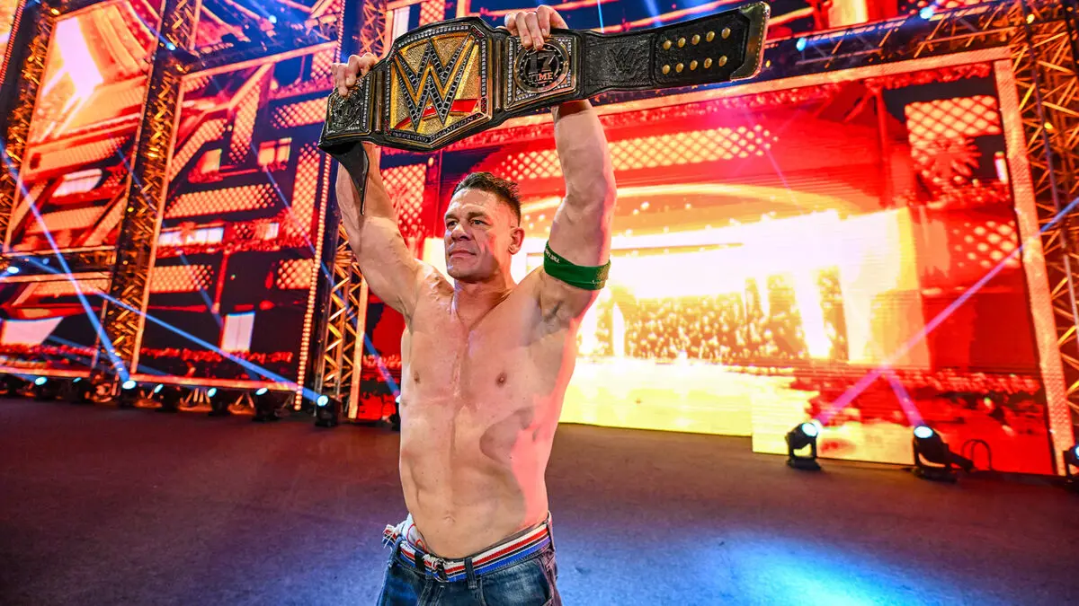 John Cena celebrates with the WWE Undisputed Championship after defeating CM Punk in the Night of Champions