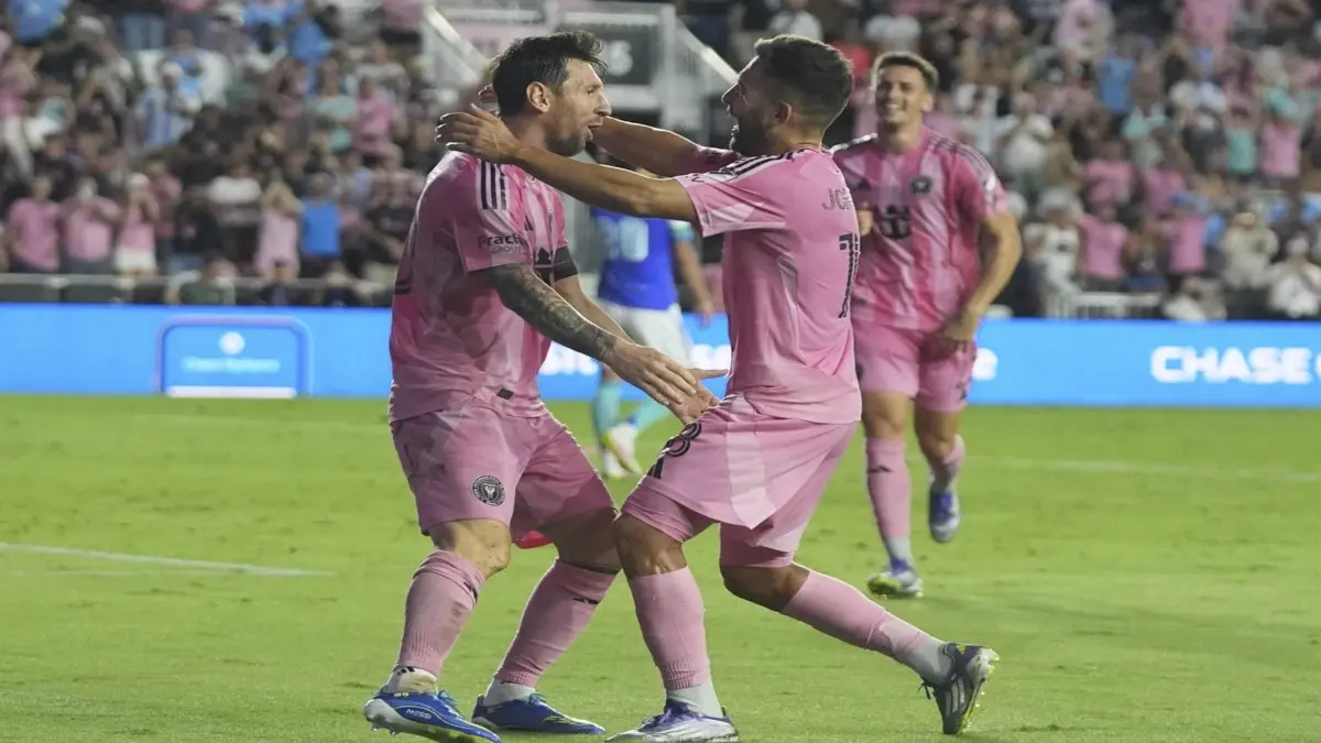 Jordi Alba celebrates a goal with Lionel Messi