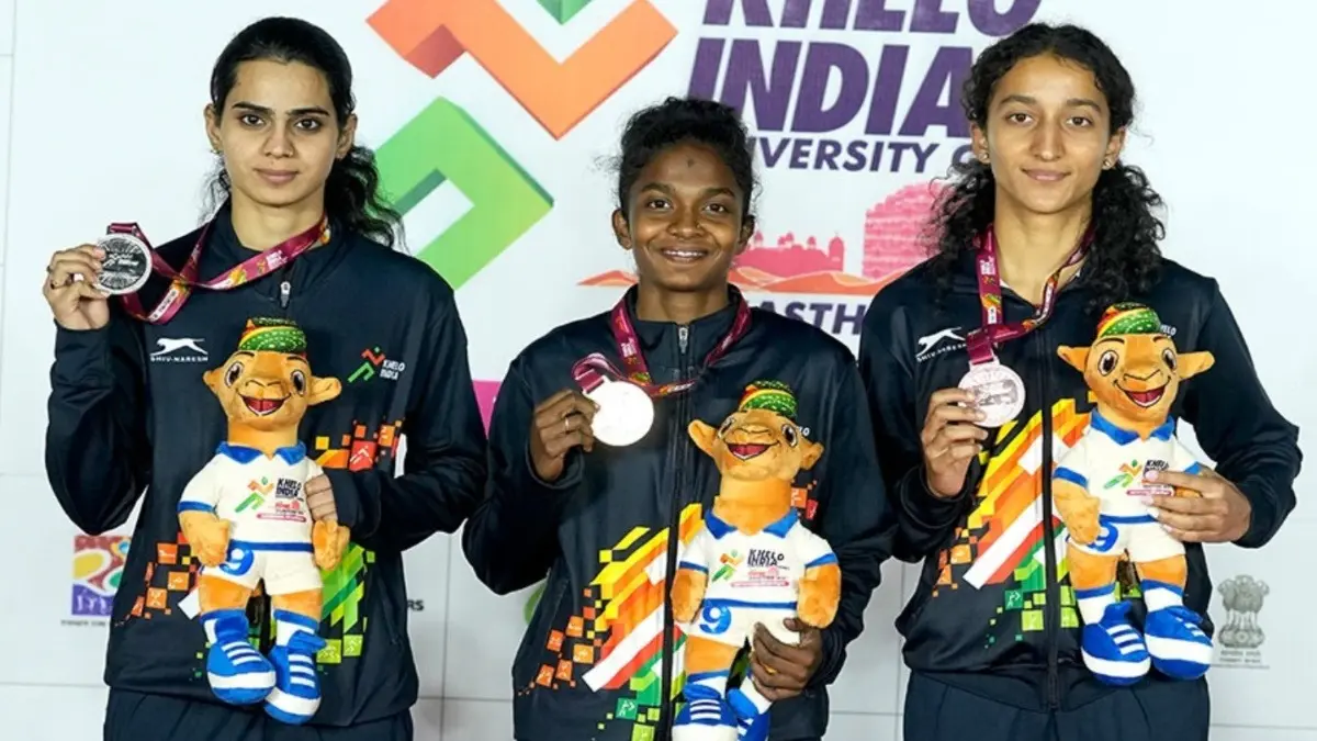 Keerthana in the center after winning gold medal at KIUG 2025