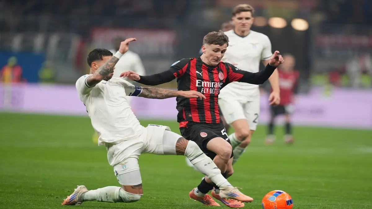 Lazio's Mattia Zaccagni fights for a ball with AC Milan's Alexis Saelemaekers