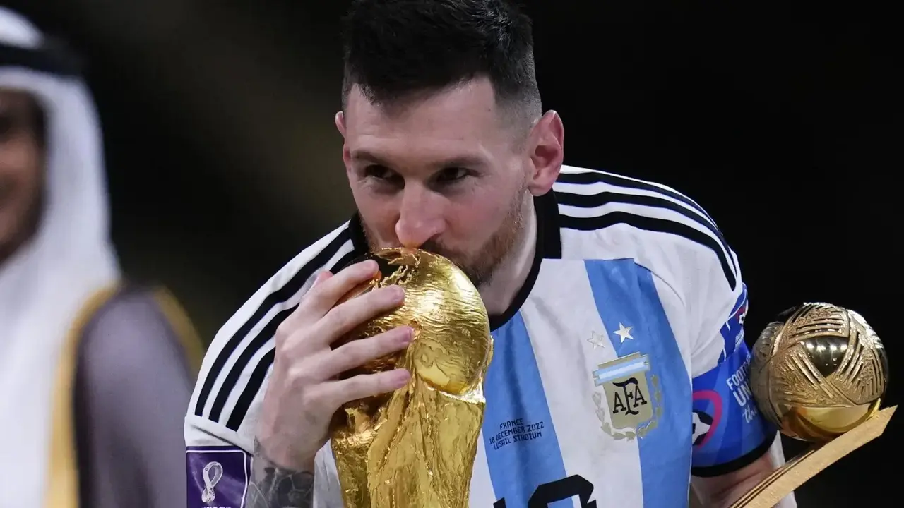 Lionel Messi celebrates after winning the World Cup trophy