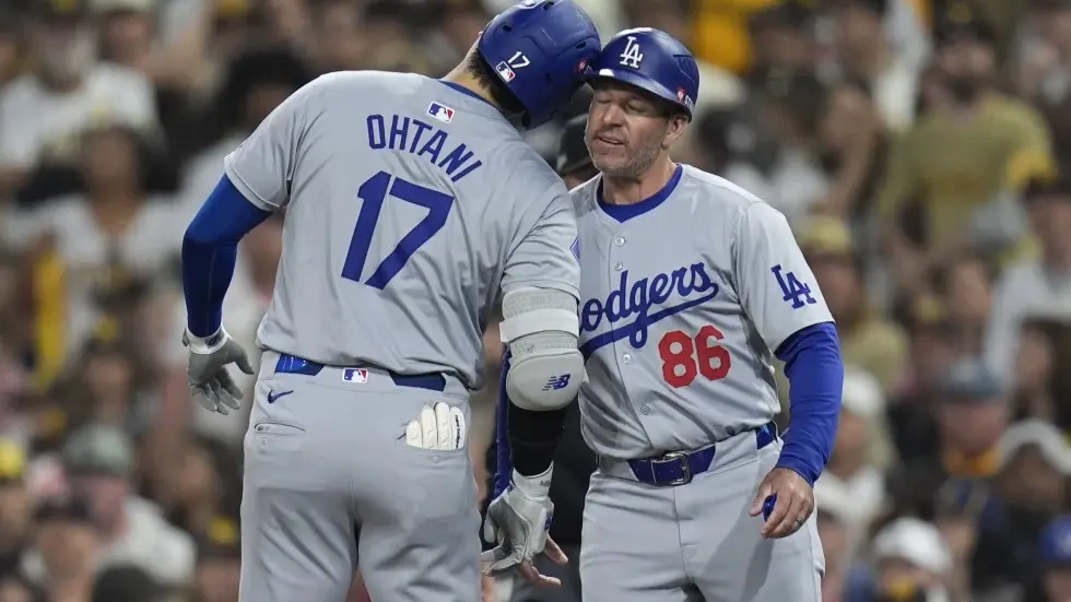 Los Angeles Dodgers’ Shohei Ohtani (17) celebrates with first base coach Clayton McCullough (86)