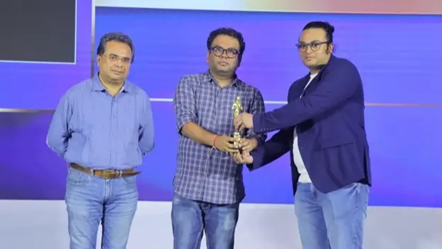 Saikat Marik, the founder, accepts the MAA Gold Award on behalf of IPRD during the summit.