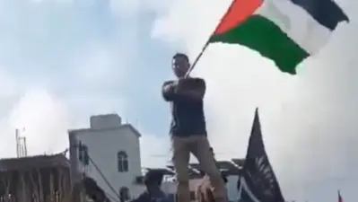 Man waves Palestinian Flag in Dumka