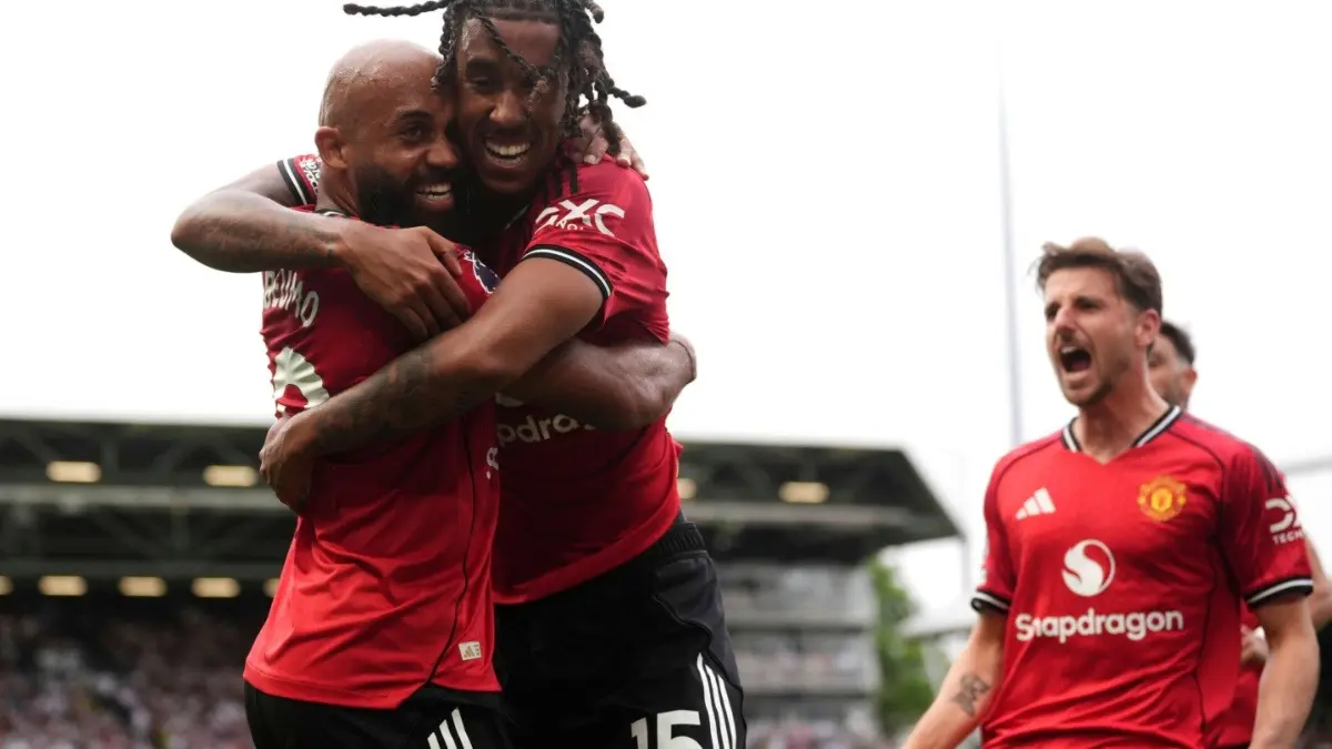 Manchester United players celebrate after scoring against Fulham in the Premier League