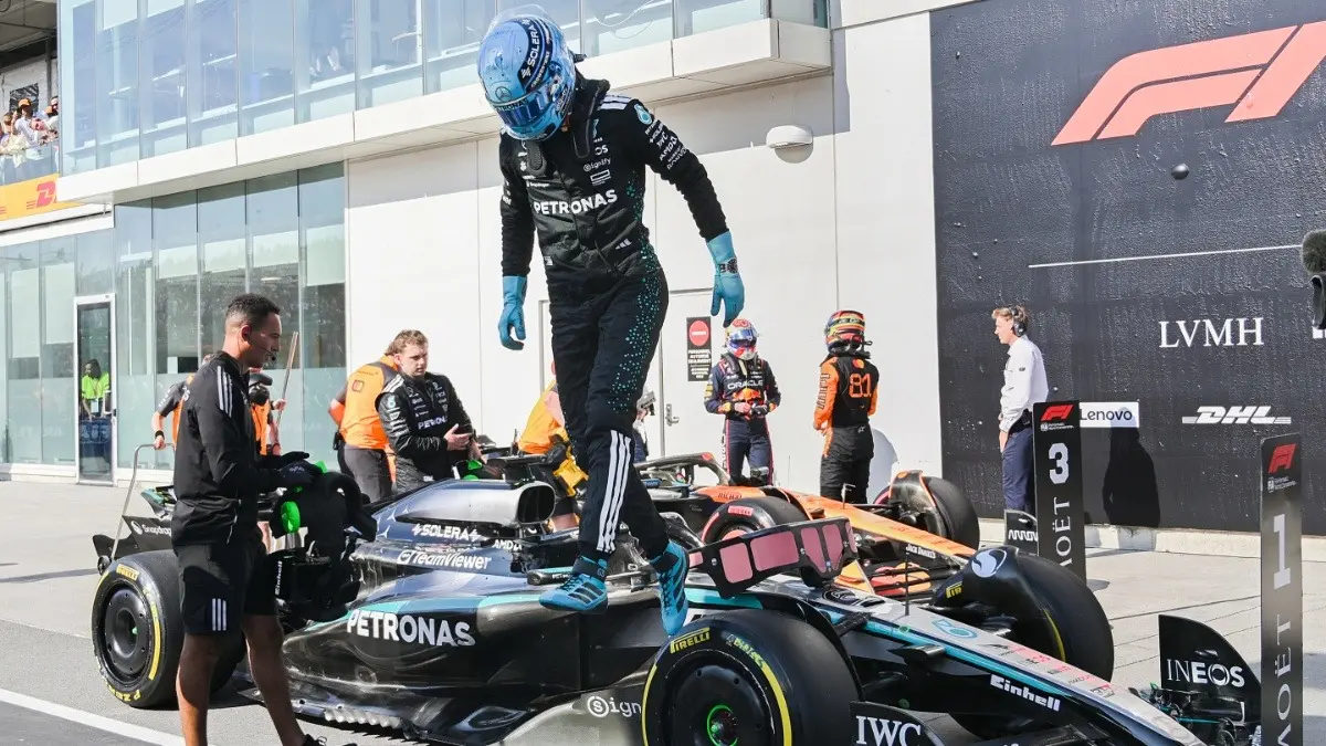 Mercedes driver George Russell jumps out of his car after taking the pole position at the F1 Canadian GP