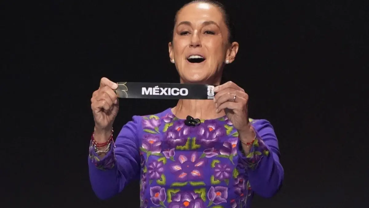 Mexican President Claudia Sheinbaum holds up the team name of Mexico