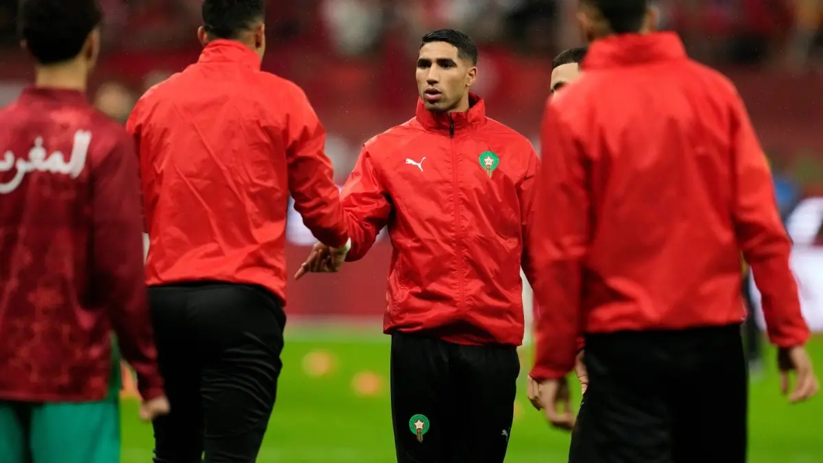 Morocco's Achraf Hakimi shakes hands with teammates ahead of the African Cup of Nations match against Mali