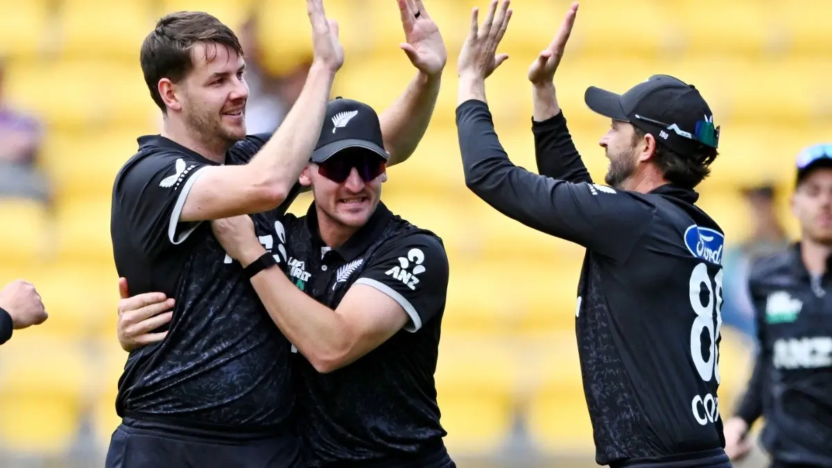 New Zealand's Jacob Duffy, Nathan Smith, and Devon Conway celebrate the wicket of Joe Root against England in 3rd ODI