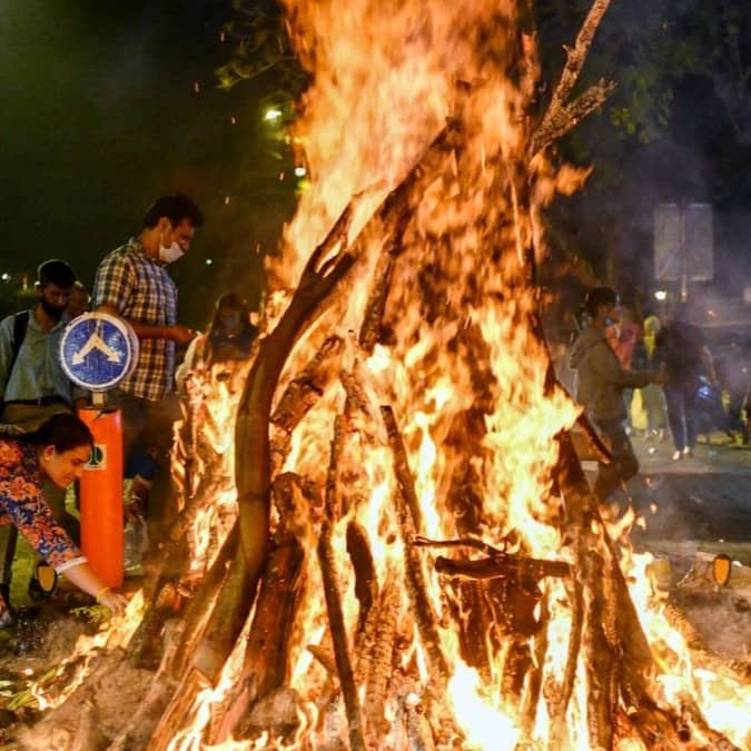 People celebrating Happy Holi 2026 with colorful gulal and water during spring festival in India