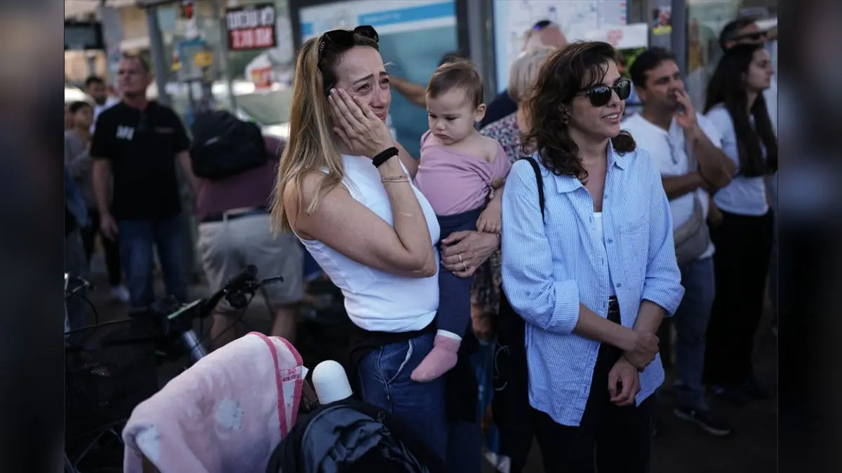 People react as they gather to watch a live broadcast of Israeli hostages released from Gaza at a plaza known as hostages square in Tel Aviv, Israel, Monday.
