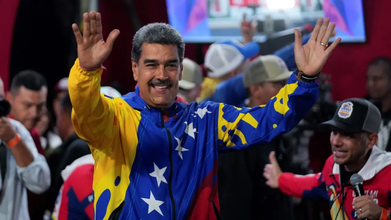 President Nicolas Maduro addresses supporters gathered outside the Miraflores presidential palace after electoral authorities declared him the winner of the presidential election in Caracas,